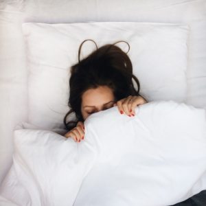 a woman practices better sleep habits